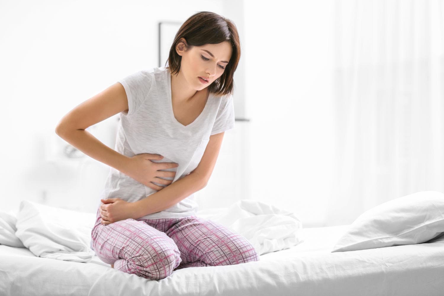 Donna che si tocca la pancia a causa di dolore