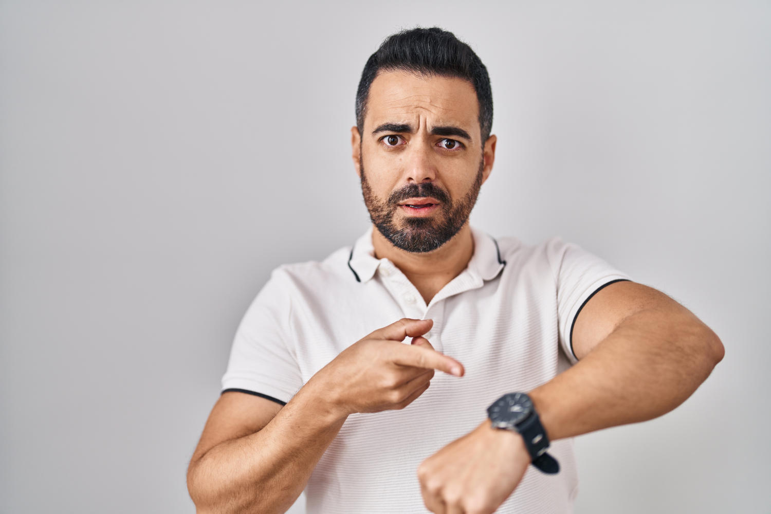 Uomo indica l'orologio sul polso