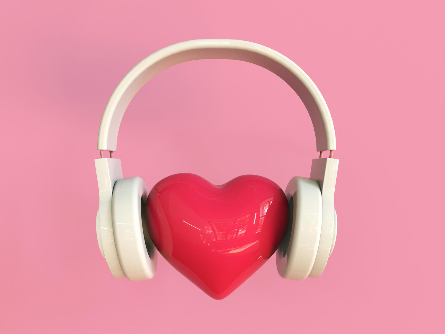 Immagine concettuale di un paio di cuffie attorno a un cuore rosso