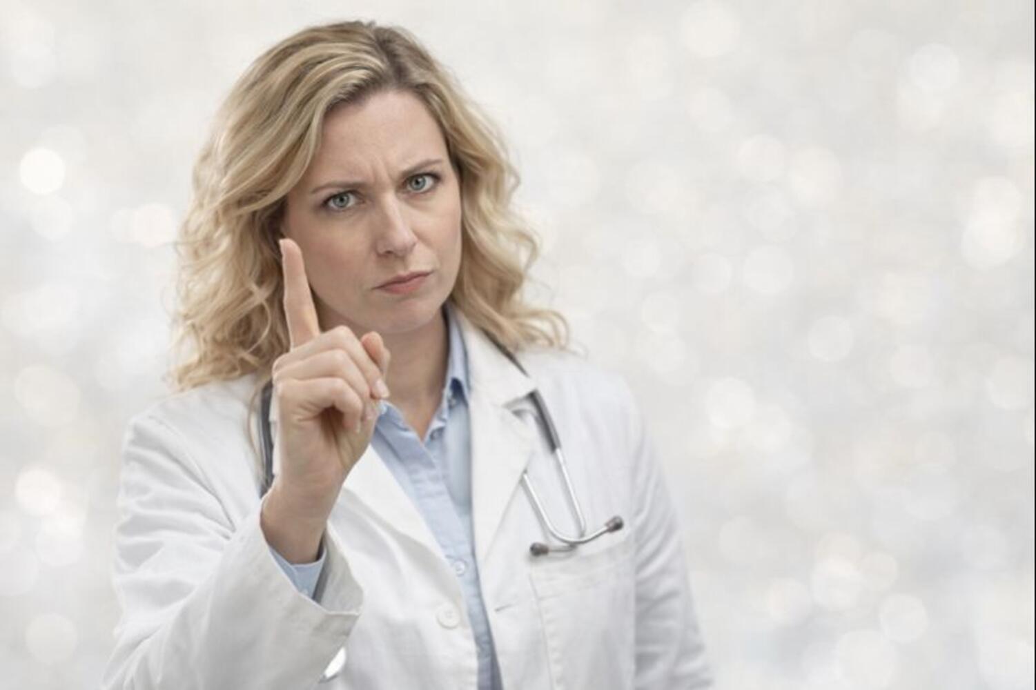 Medico in posa che sembra a dire "Attenzione"